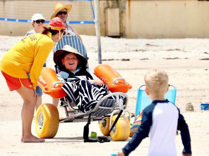 A young boy enjoys the floating chairs as part of the Inclusive Beaches Program [Source: Henley Surf Live Saving Club Facebook]