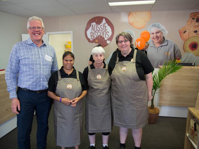 Brett Lacey with Aussie Biscuits' supported employees [Source: House with No Steps]