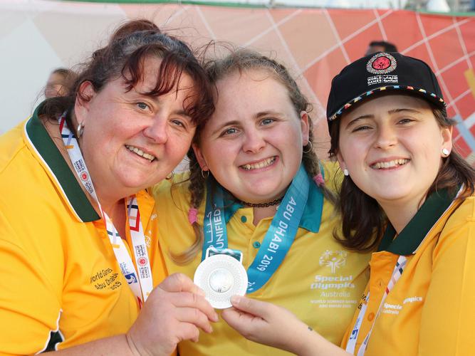 Rachel Fenwick (middle) with one of her medals [Source: Bedford Group]