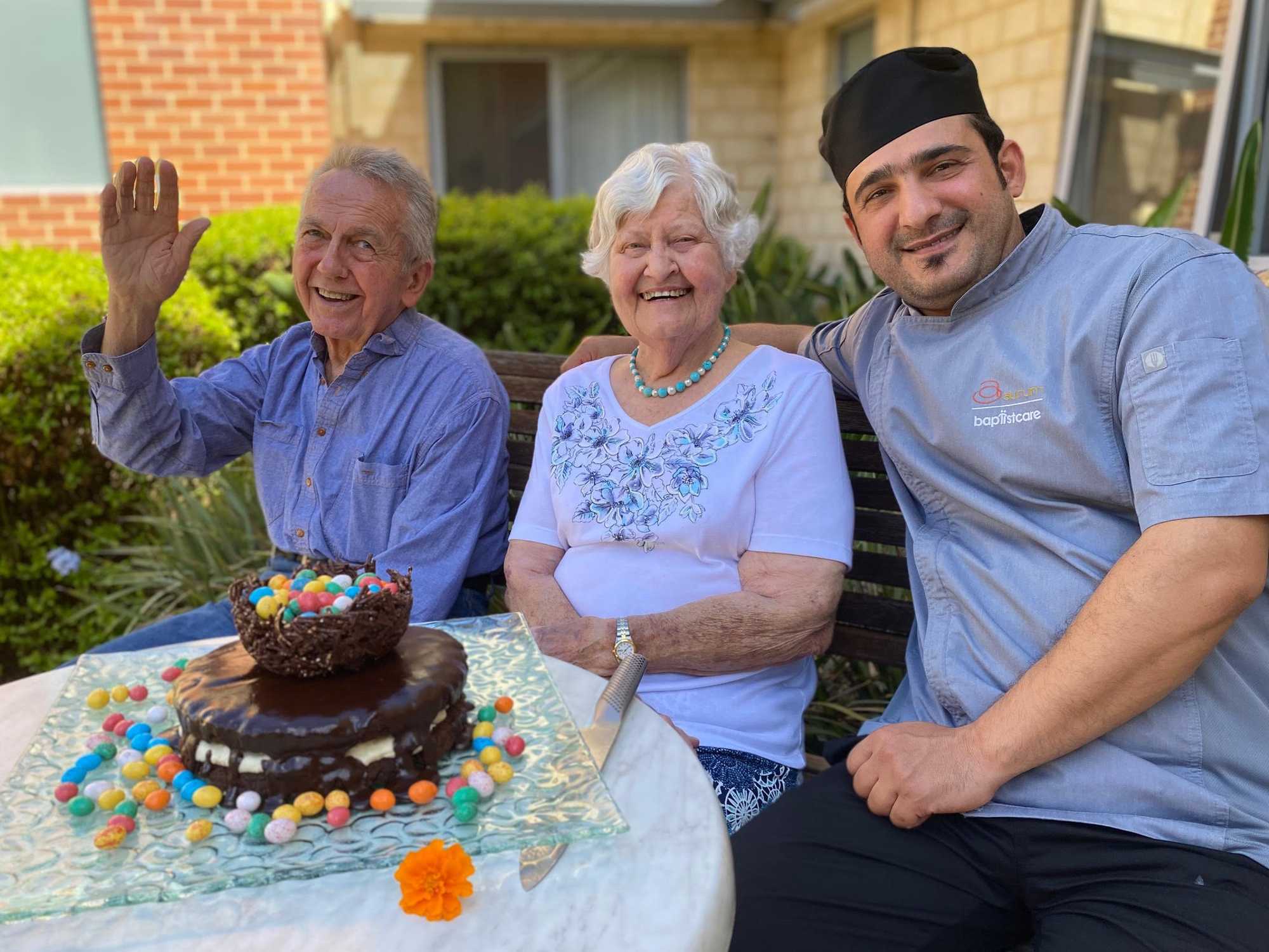 Two aged care residents with their facility chef and the special Easter treat he made