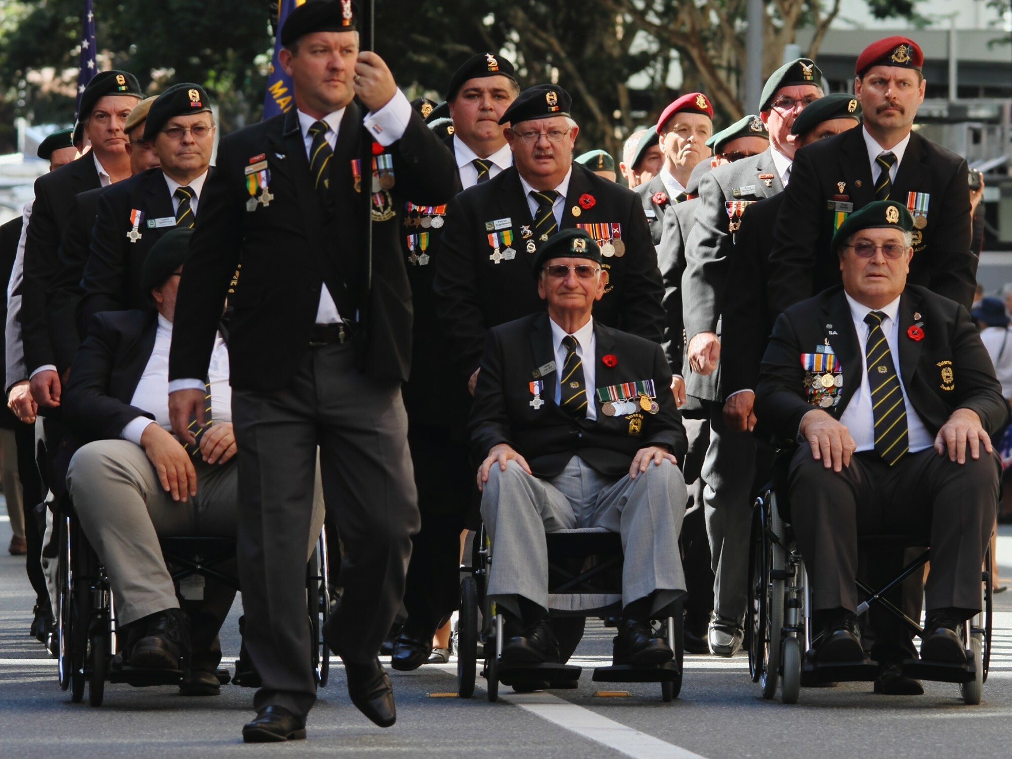 Parade of veterans in uniform.