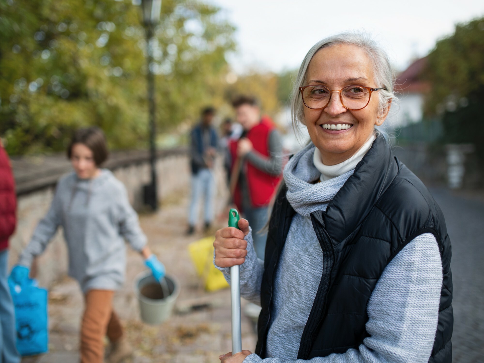 Older woman volunteering at a city clean up