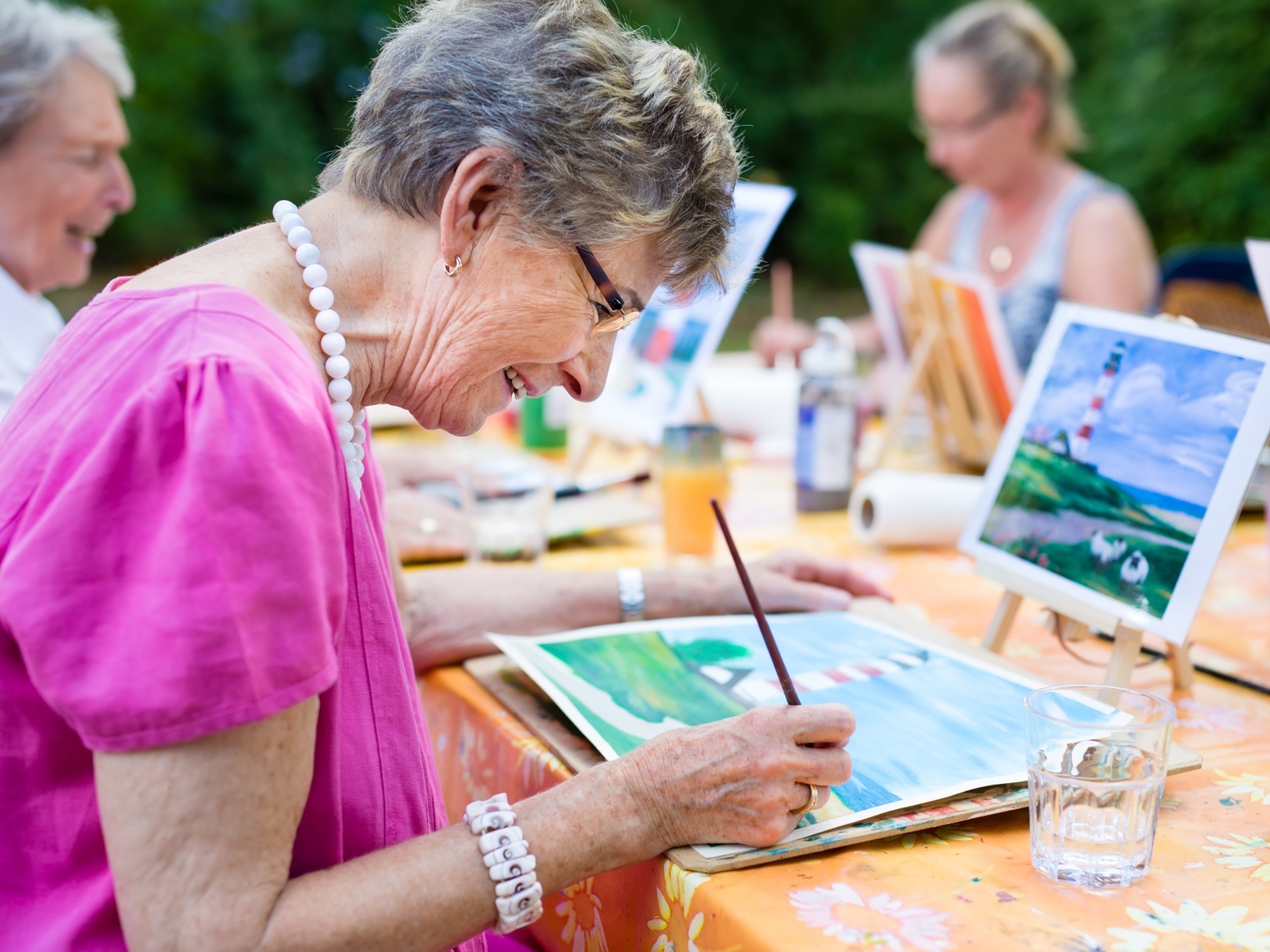 Group of residents painting at their aged care home