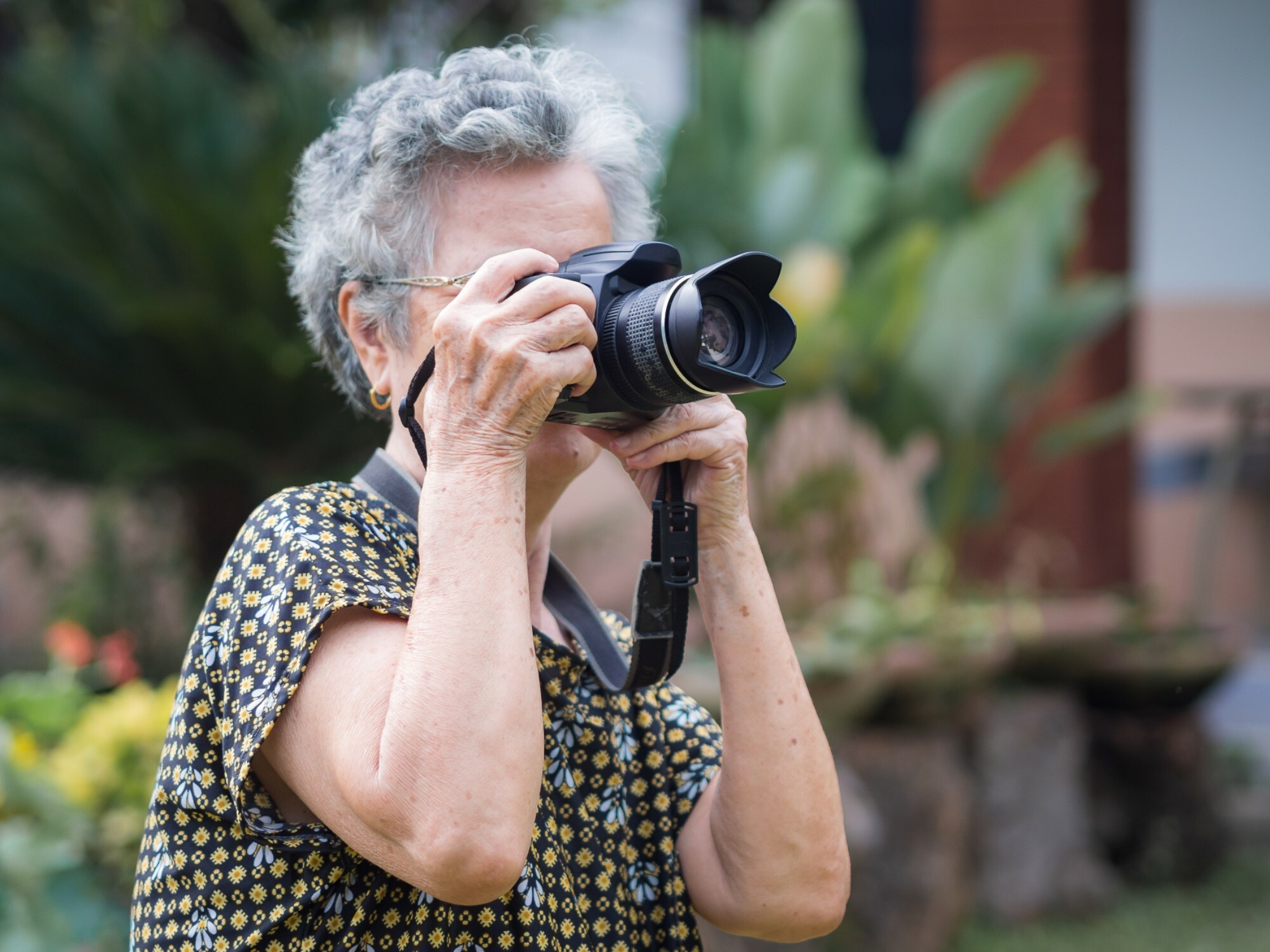 Older woman taking photos while on holiday