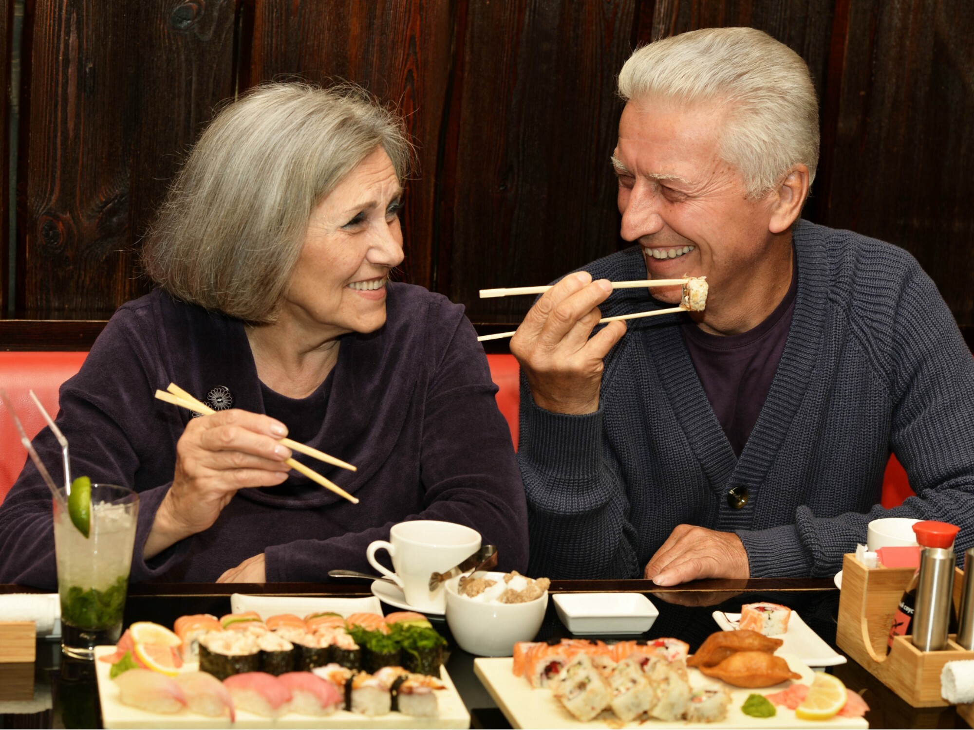 Older couple on a date eating sushi