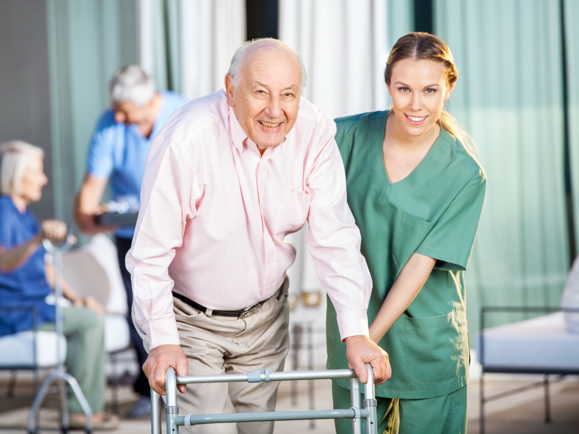 An older man getting assistance from an aged care worker