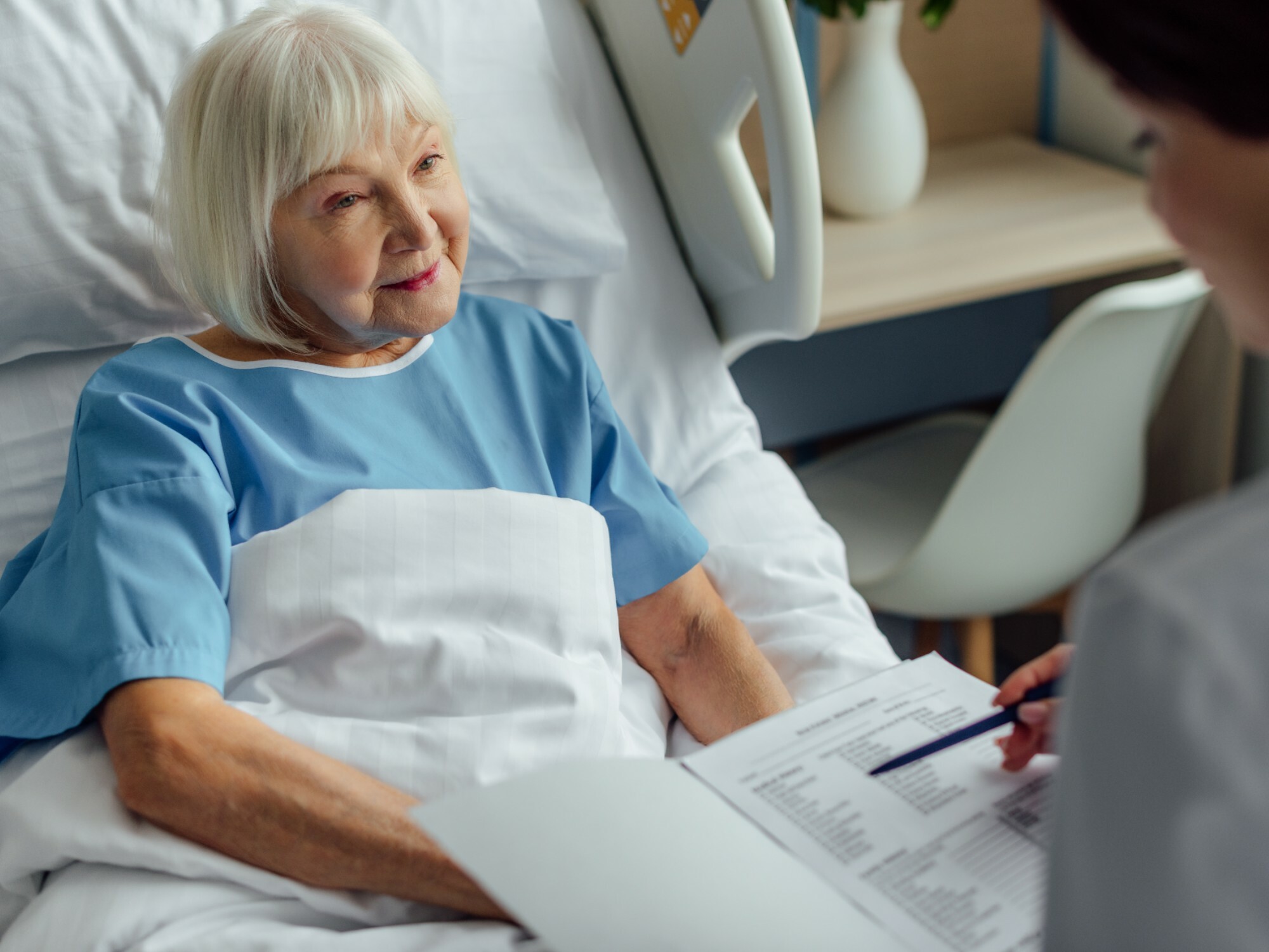 Older woman talking to a discharge planner in hospital