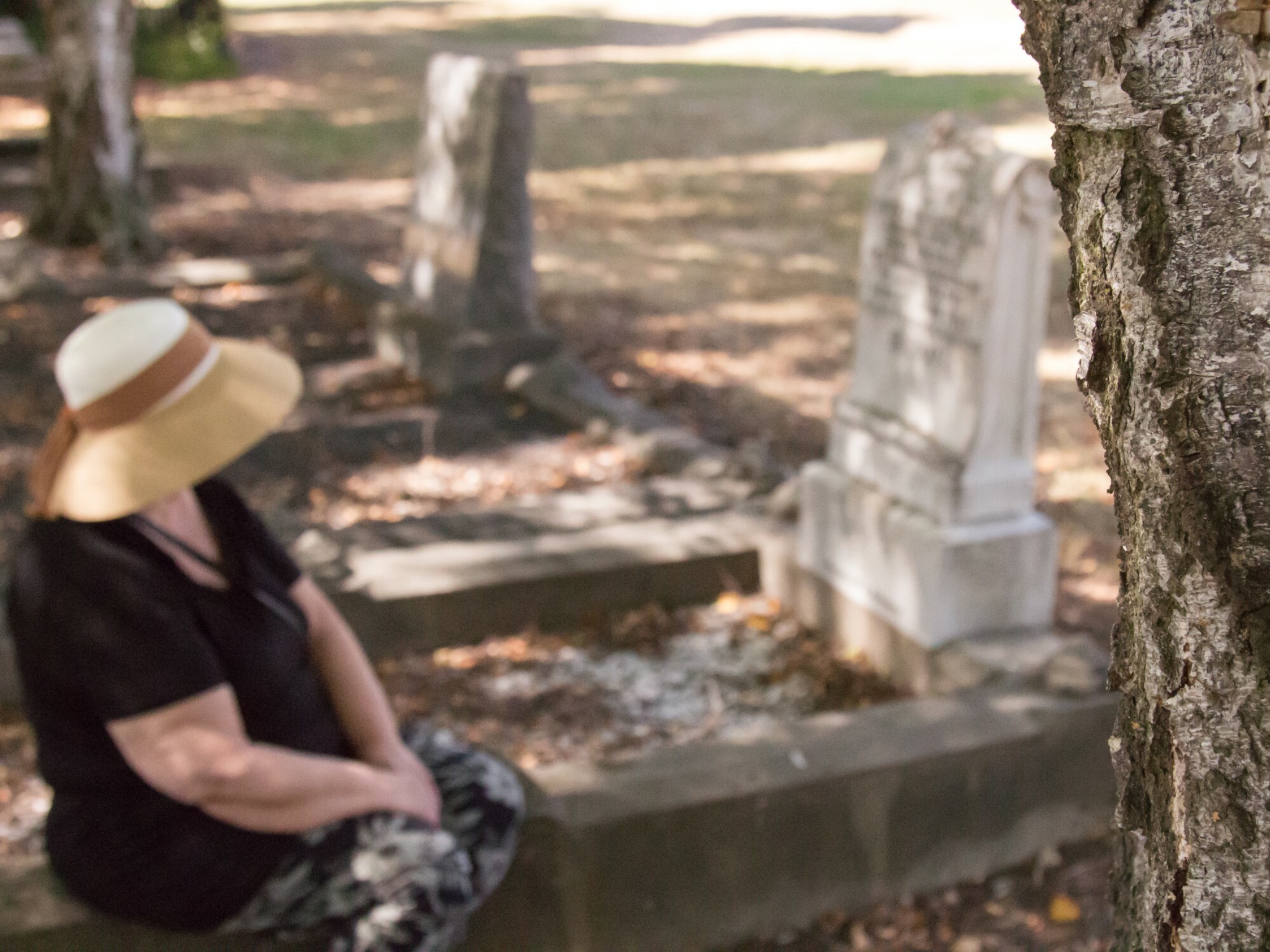 Older woman visiting a grave