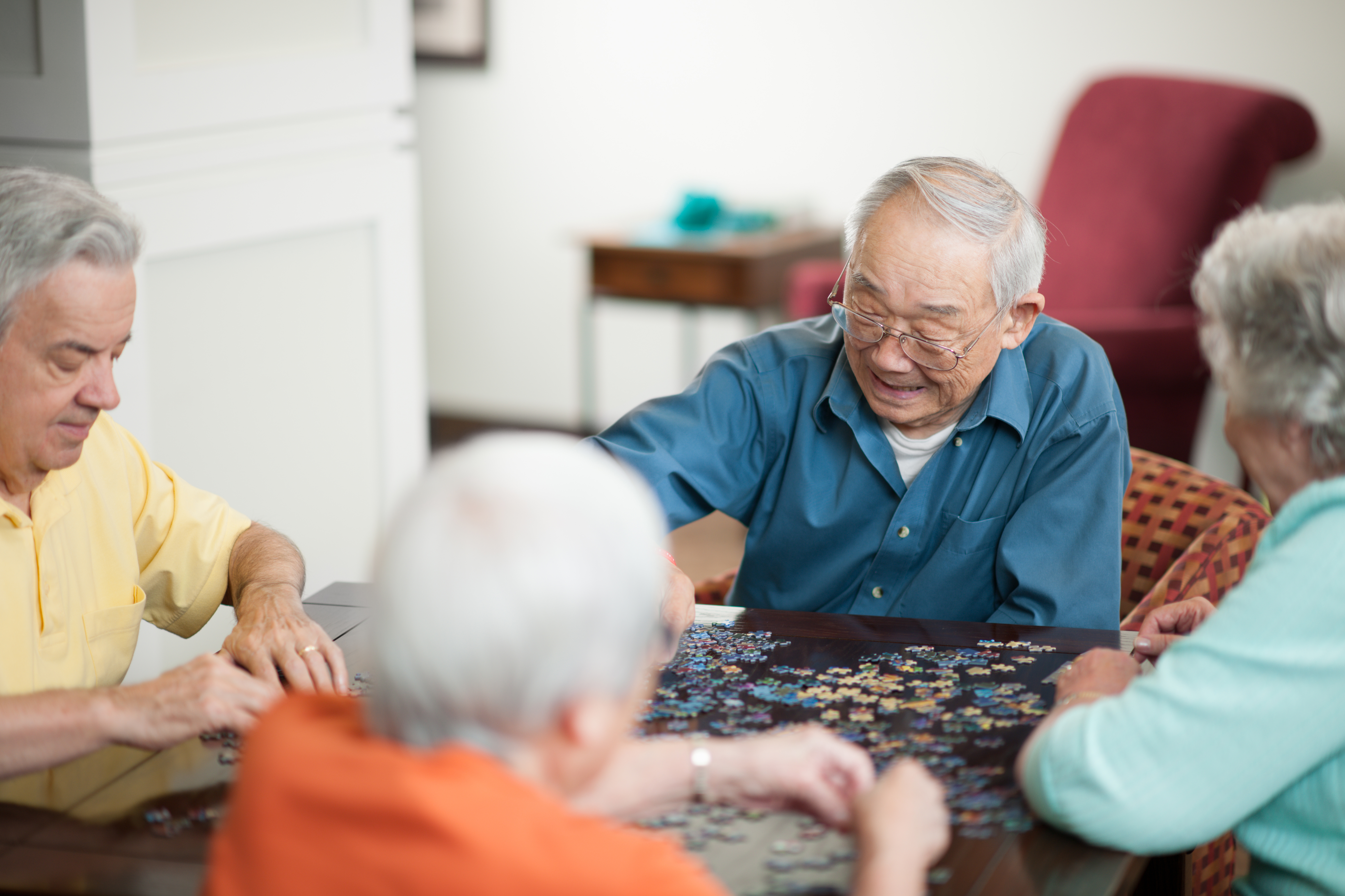 Group of older people doing a puzzle together