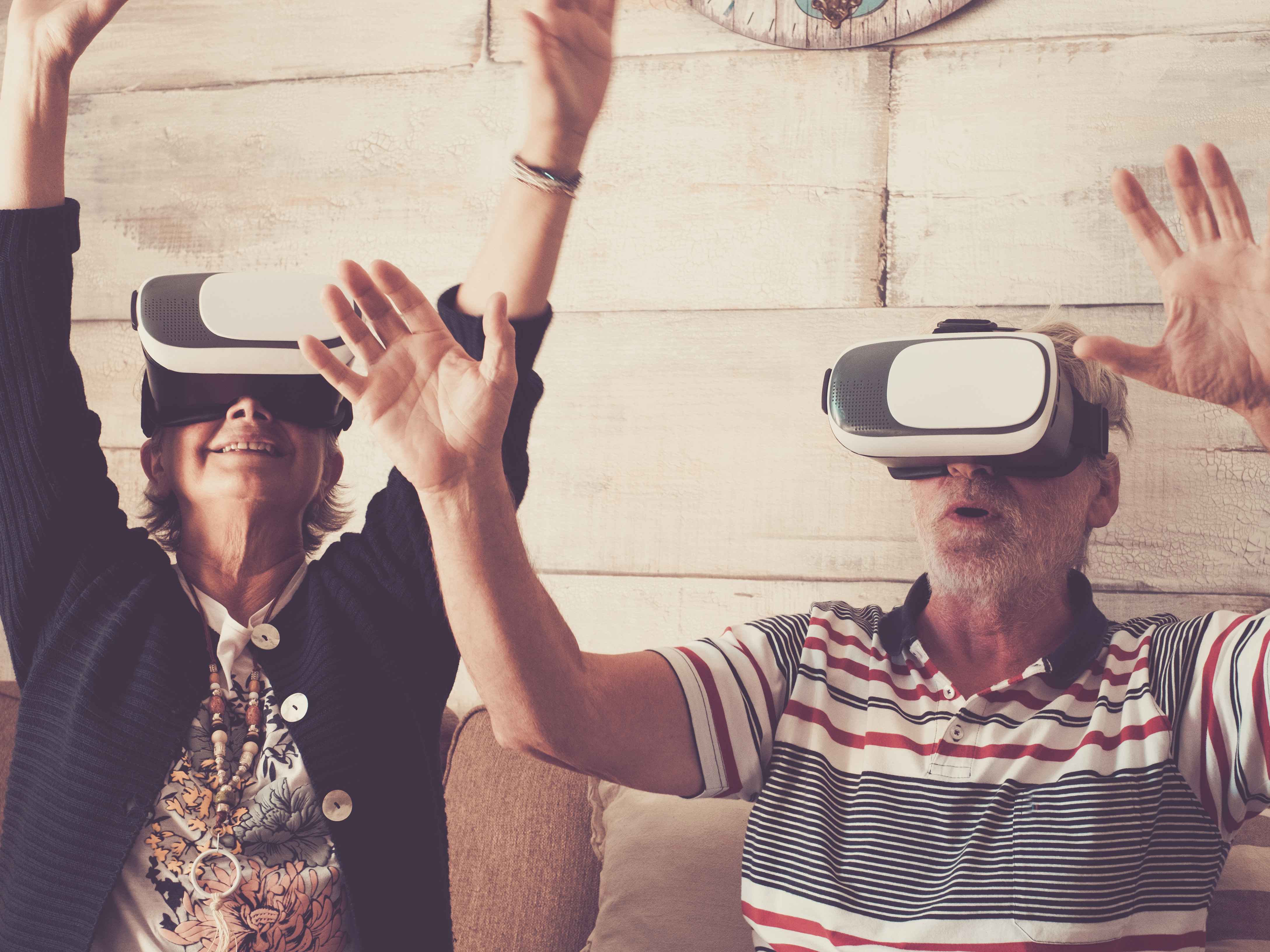An older couple are experiencing the wonders of virtual reality.