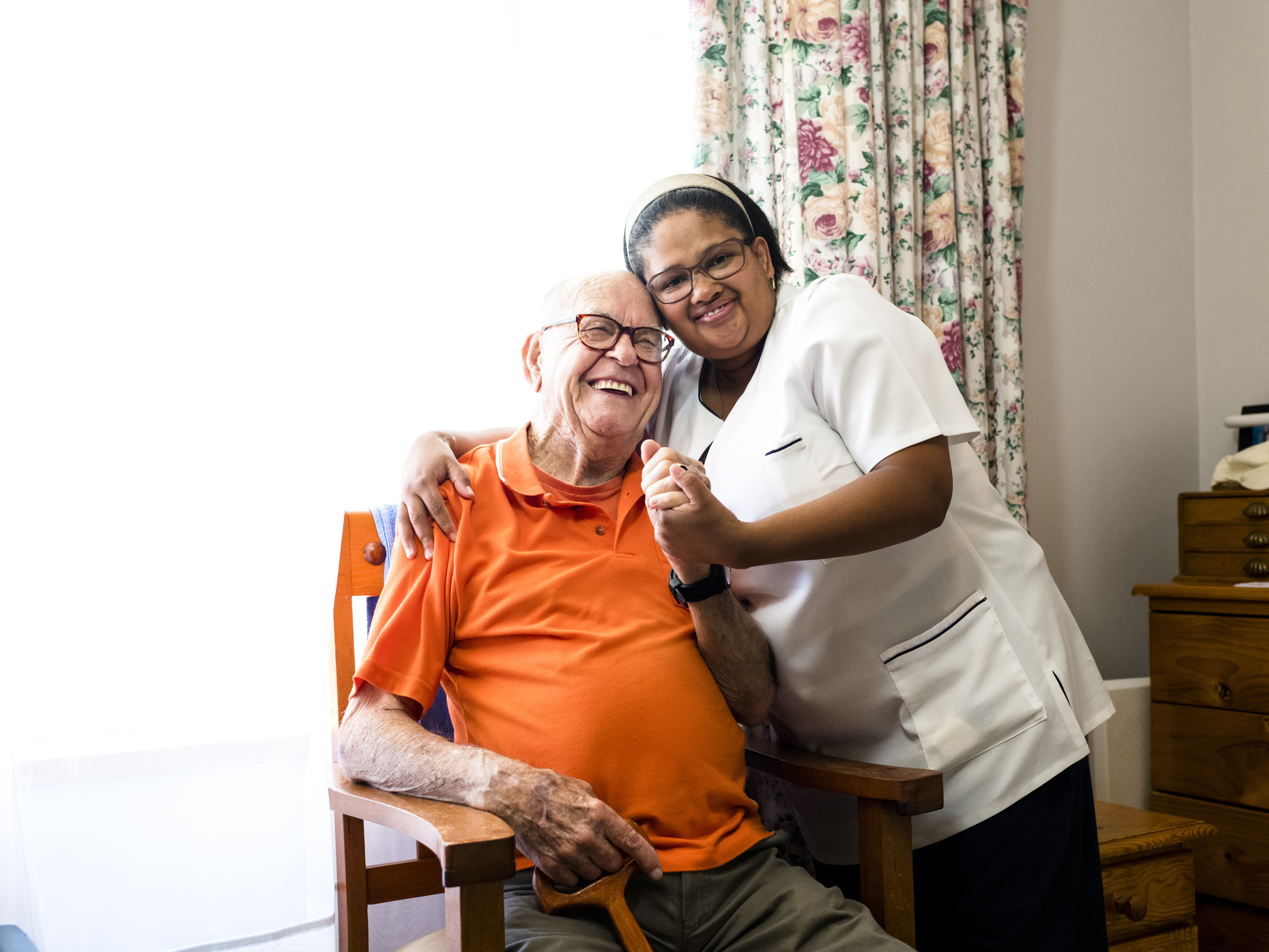 Older person at home with their carer. 